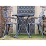 A contemporary coated cast aluminium three piece garden terrace set comprising circular top table