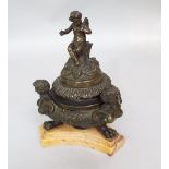 A 19th century Grand Tour bronze inkwell and cover, the finial surmounted by a winged cherub over