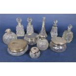 A collection of silver and glass dressing set items, comprising four silver topped powder jars and 7