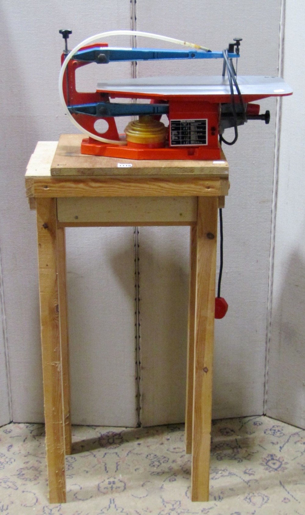 A Hegner Multicut-2 workshop electric fret saw mounted on a simple pine stand, together with a