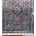 Persian full pile rug with central navy blue medallion and intricate geometric decoration, upon a