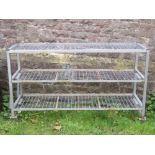A useful fabricated steel framed trolley of rectangular form on three tiers with galvanised square