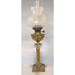 A Victorian brass table standing oil lamp with wrythen fluted column on a square cut base with