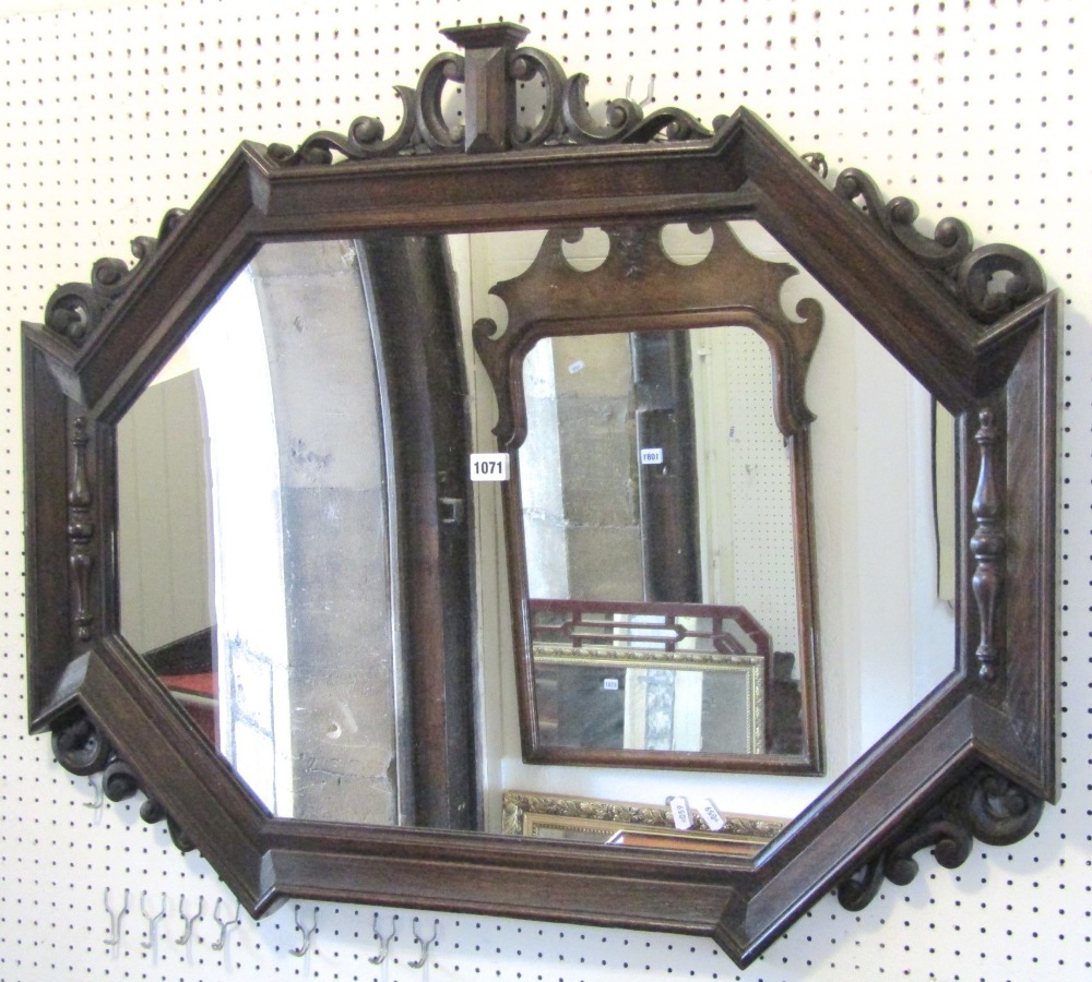 An Edwardian/1920s wall mirror, the elongated oak octagonal geometric moulded frame with applied