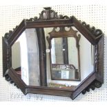 An Edwardian/1920s wall mirror, the elongated oak octagonal geometric moulded frame with applied
