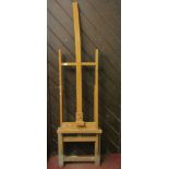 A floor standing stained beechwood adjustable artist easel with folding framework
