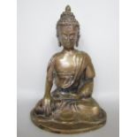 Eastern cast bronze figure of a seated Buddhistic deity in the lotus position, 17 cm high