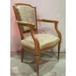 A fauteuil with floral patterned tapestry upholstered seat and padded back on a yellow ground,