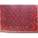 Persian runner centrally decorated with a floral geometric decoration upon a red ground, 225 x