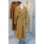 Seven woollen full length ladies coats in camel shades, including coat with faux fur collar, size