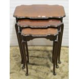 A nest of three graduated occasional tables of rectangular form, with shaped and moulded outline and