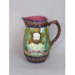 A 19th century majolica jug with relief moulded and decorated portraits of a bearded gentleman,