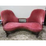 A Victorian conversation couch, with carved mahogany showwood frame, spiral twist detail and red