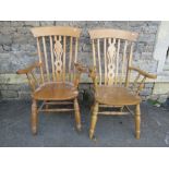 A pair of contemporary Windsor beechwood lathe back armchairs with central pierced splats raised