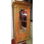 A stripped and waxed satin walnut wardrobe in the Art Nouveau manner, the central mirror panelled