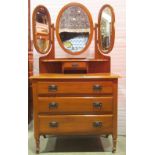 An Edwardian walnut dressing chest with triple oval framed and folding mirror back with bevelled