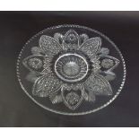 Good quality cut glass charger with flower head decoration and geometric star cut panels, 43cm