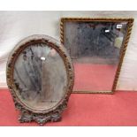 A 19th century toilet mirror with easel back, the oval framework with repeating acanthus detail,