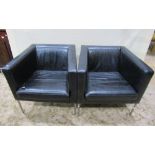 A pair of contemporary but retro style stitched black faux leather upholstered armchairs of