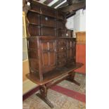 An Ercol dresser and plate rack, the central four drawers flanked by two cupboards together with a