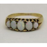 Graduated five stone opal ring in high carat gold, marks worn, size N, 2.7g
