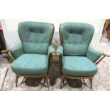 A pair of Ercol dark stained beechwood stick and slightly winged back armchairs with loose