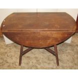 A Ercol dark stained elm and beechwood oval drop leaf dining table, raised on square cut and moulded