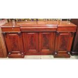 A Victorian mahogany inverted breakfront sideboard enclosed by four arched and moulded panelled