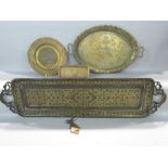 Four Indian brass trays, together with a further Indian brass paper clip (5)