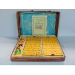 A leather cased Mahjong set with instructions