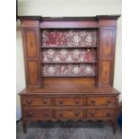 A Georgian oak countrymade dresser, the lower section enclosed by six short drawers, the raised