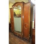 A good quality walnut breakfront triple wardrobe, the central mirror panelled door with bevelled