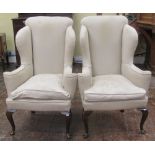 A good pair of Howard and Sons 18th century style high back wing chairs, with scrolled arms on