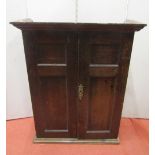 A small 18th century oak wall mounted cupboard, with simply fitted interior of shelves and