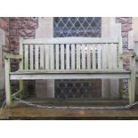 A weathered teak three seat garden bench with slatted seat and back, 150 cm long