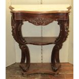 A mid-19th century mahogany console table of serpentine form raised on pierced and scrolled supports