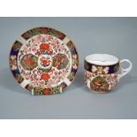 Crown Derby Imari moustache cup and saucer, with panels painted with birds and typical gilt
