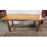 A pine refectory table, the rectangular top with moulded outline and cleated detail, raised on