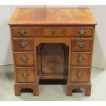 A good quality reproduction Georgian style mahogany kneehole desk with well matched flame veneered