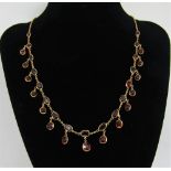 Edwardian garnet fringe necklace in yellow metal, 12.3g (one spare drop)