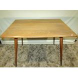 A small Ercol blonde elm and beechwood dining table of rectangular form, raised on four turned,