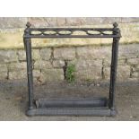 A Victorian cast iron umbrella stand of rectangular form with six circular divisions and