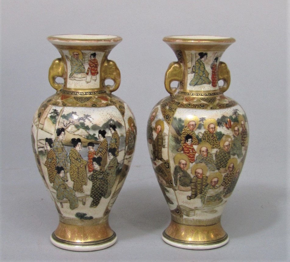 A pair of early 20th century Satsuma two handled vases with painted and gilded multiple figure