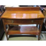 An inlaid Edwardian mahogany bow fronted two tier side table, with crossbanded and string inlaid