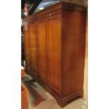 Substantial French cherry wood four door wardrobe with central division, full length panelled