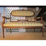 A late 19th century three piece salon suite comprising a two seat sofa and a pair of matching open