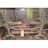An old ironwork fire basket, the andirons with twisted stems, spear head finials and scroll