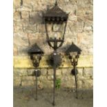 Ironwork wall mounted torch lantern, the square tapered hood with scrollwork repeating detail