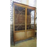 A 19th century faded mahogany display cabinet freestanding and enclosed by a pair of partially