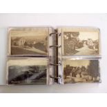 An album containing a quantity of both colour and black and white postcards of Wotton Under Edge,